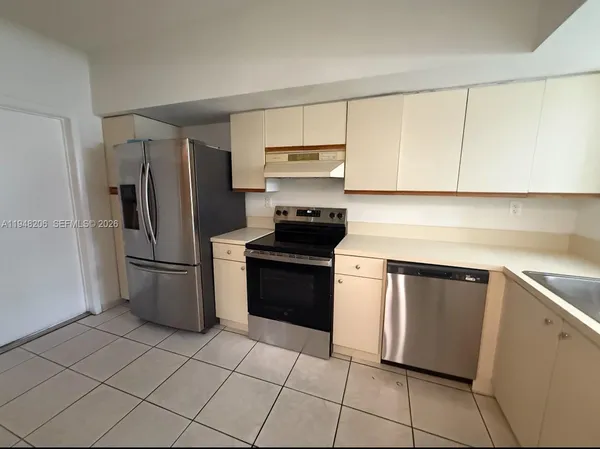 a kitchen with cabinets and stainless steel appliances