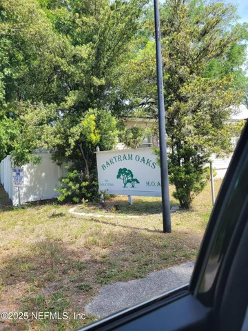 a view of a tree front of house