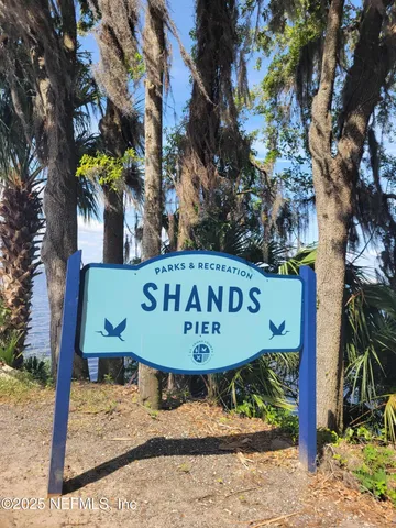 a view of a wooden fence with a tree