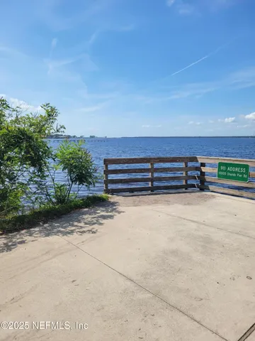 a view of a bench with wooden fence