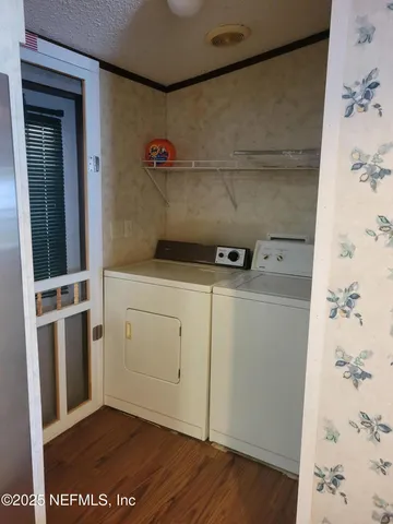 a view of storage and utility room with washer and dryer