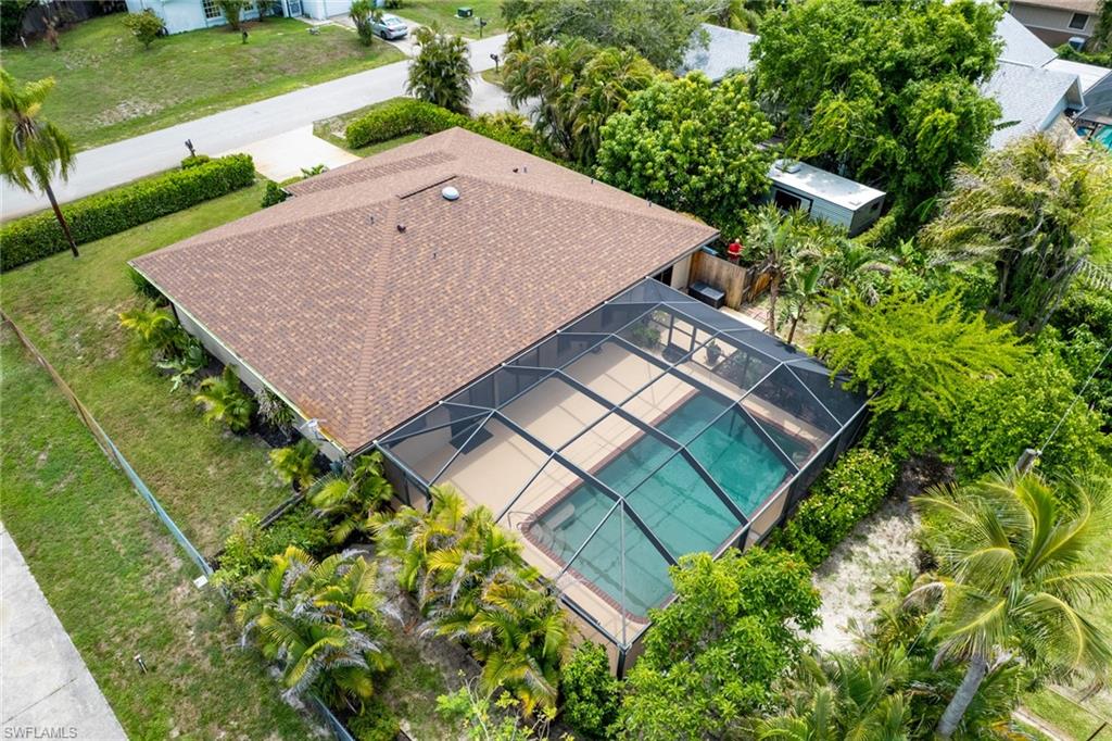 18414 Tulip Road Fort Myers, FL 33967 - Photo 30 of 37 Rear exterior featuring a large screened swimming pool enclosure