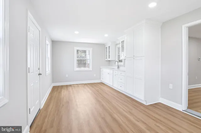 a view of a kitchen with wooden floor and electronic appliances