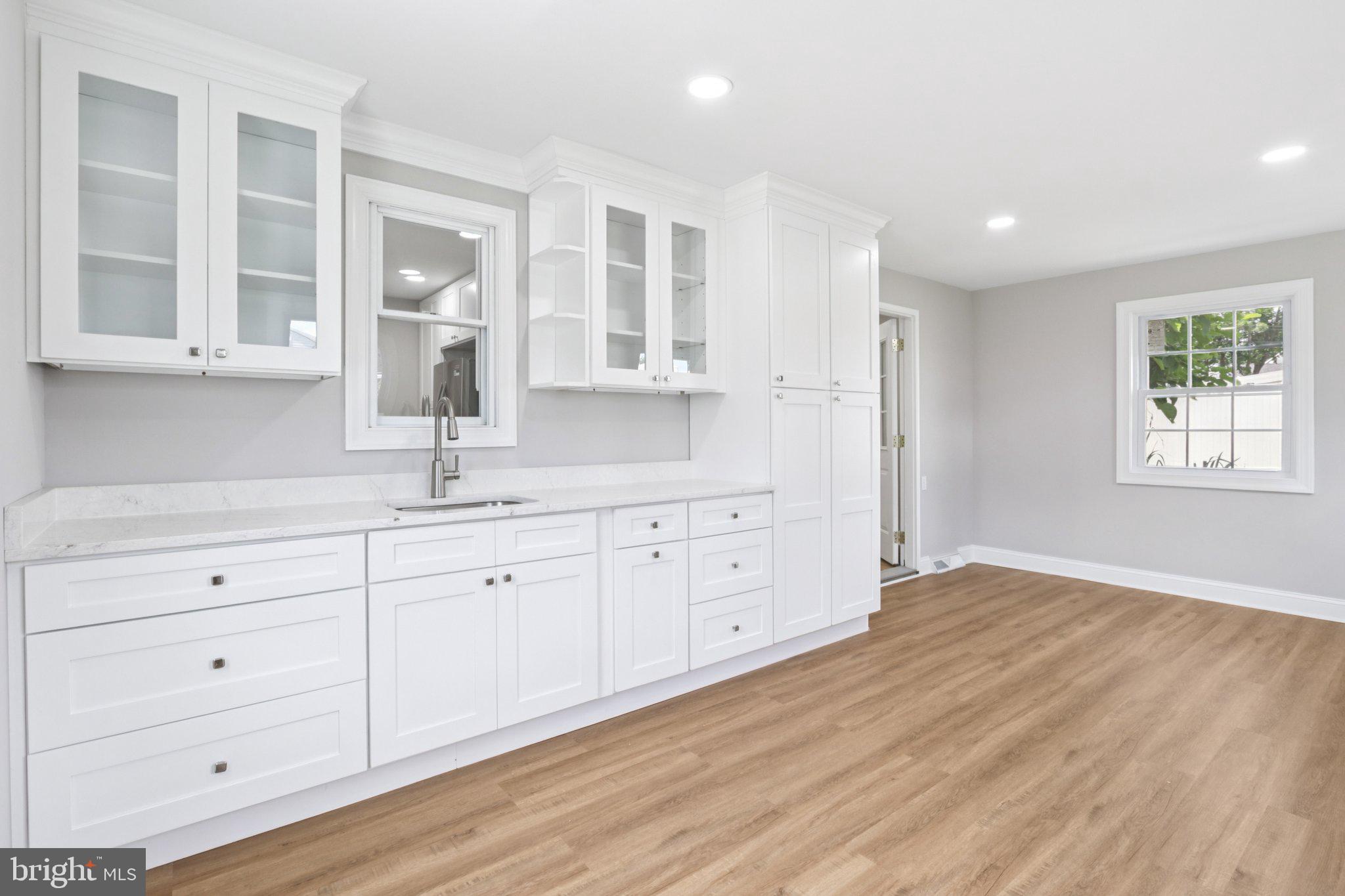 1 Russell Road New Castle, DE 19720 - Photo 15 of 49 a hall with white cabinets and wooden floor