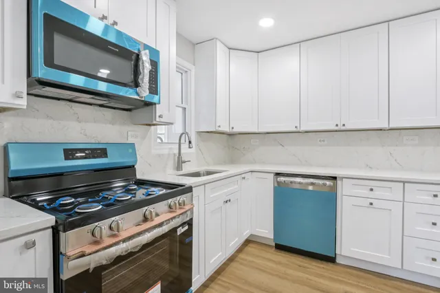 a kitchen with stainless steel appliances granite countertop a stove and a microwave