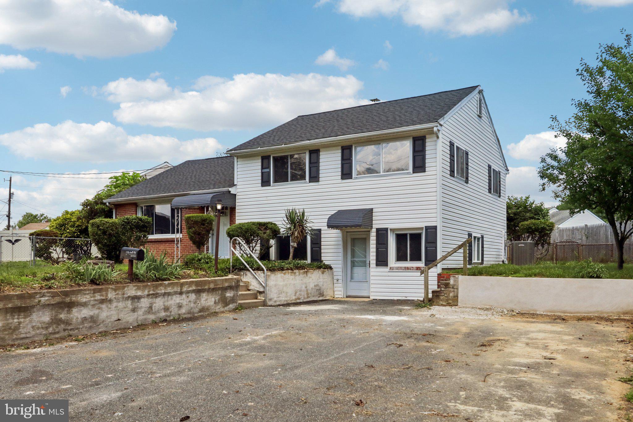 1 Russell Road New Castle, DE 19720 - Photo 2 of 49 a front view of a house with a yard and garage