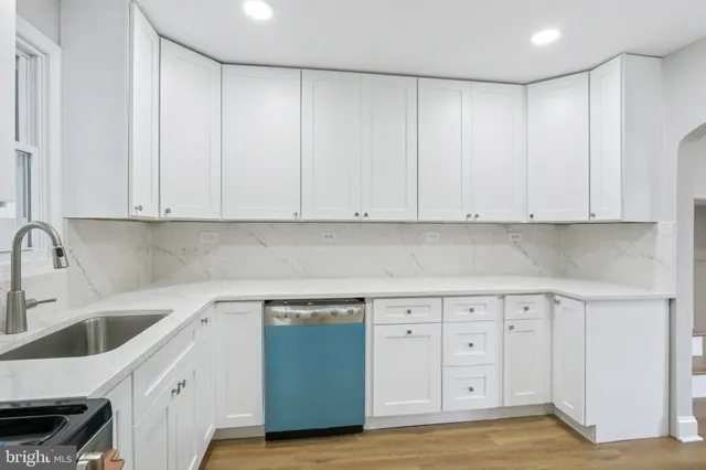a kitchen with white cabinets and a sink