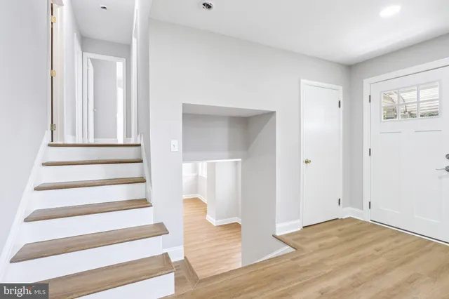 a view of an entryway with wooden floor and windows