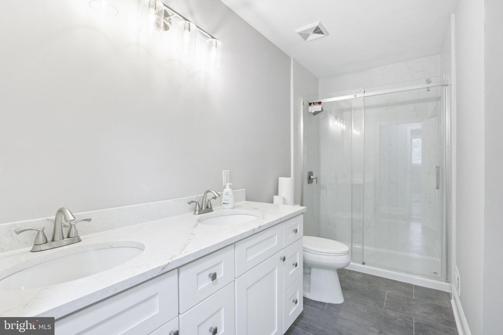 1 Russell Road New Castle, DE 19720 - Photo 25 of 49 a bathroom with a double vanity sink toilet and shower