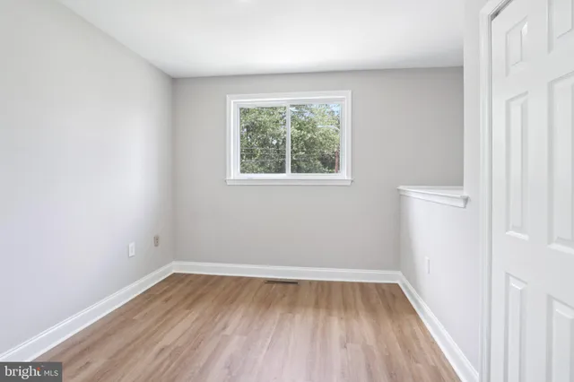 a view of a room with wooden floor and window
