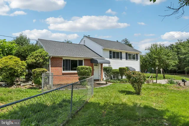 a view of a house with a yard and sitting area