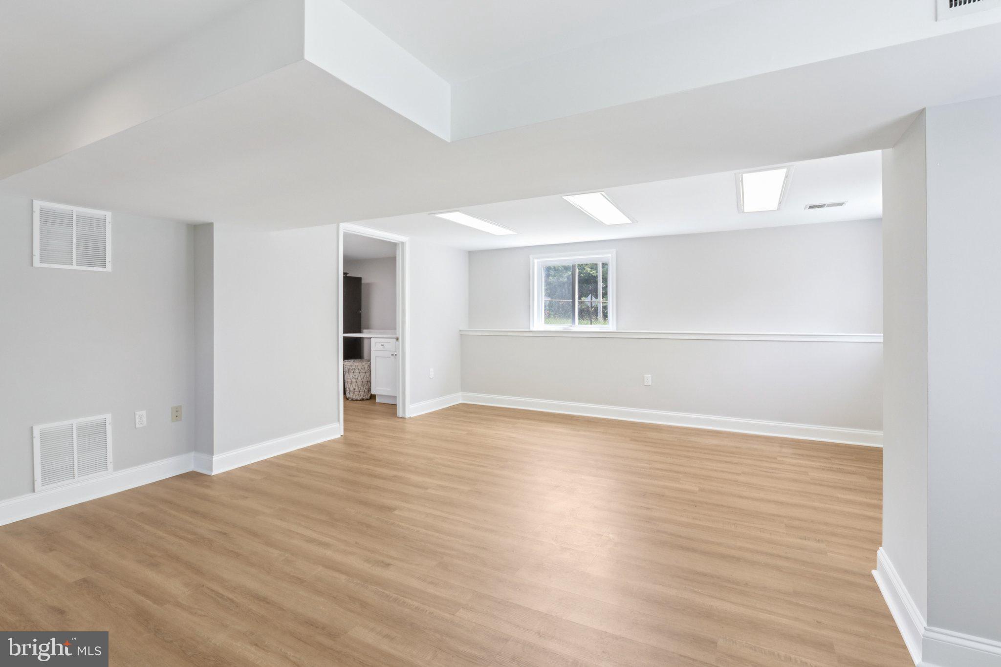 1 Russell Road New Castle, DE 19720 - Photo 35 of 49 a view of an empty room with wooden floor and a window