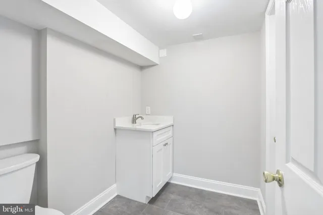 a bathroom with a sink a toilet and vanity