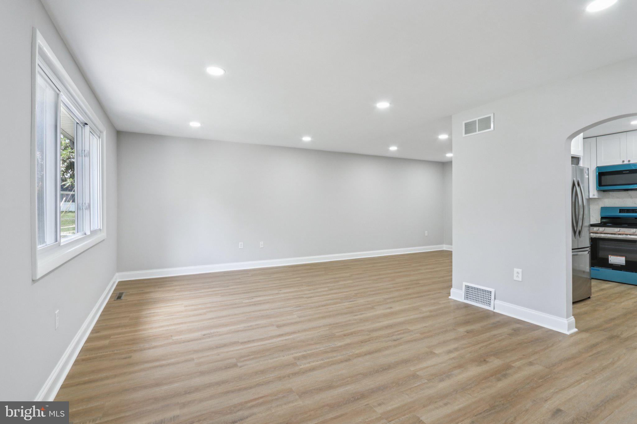1 Russell Road New Castle, DE 19720 - Photo 5 of 49 a view of an empty room with wooden floor and a window