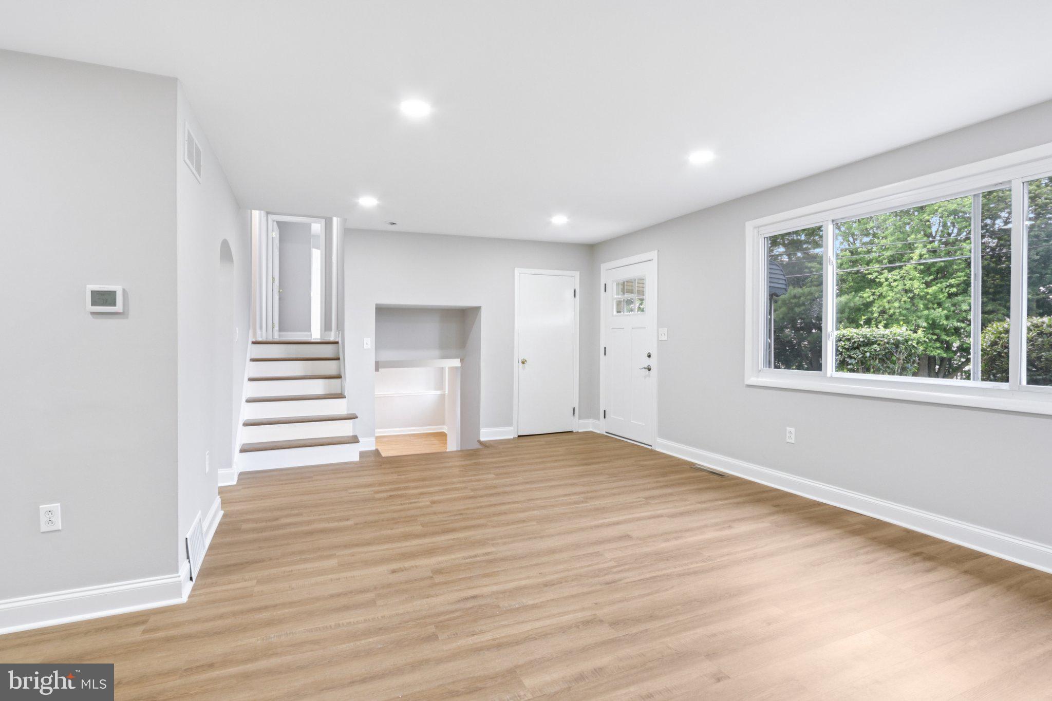 1 Russell Road New Castle, DE 19720 - Photo 7 of 49 a view of empty room with wooden floor and window