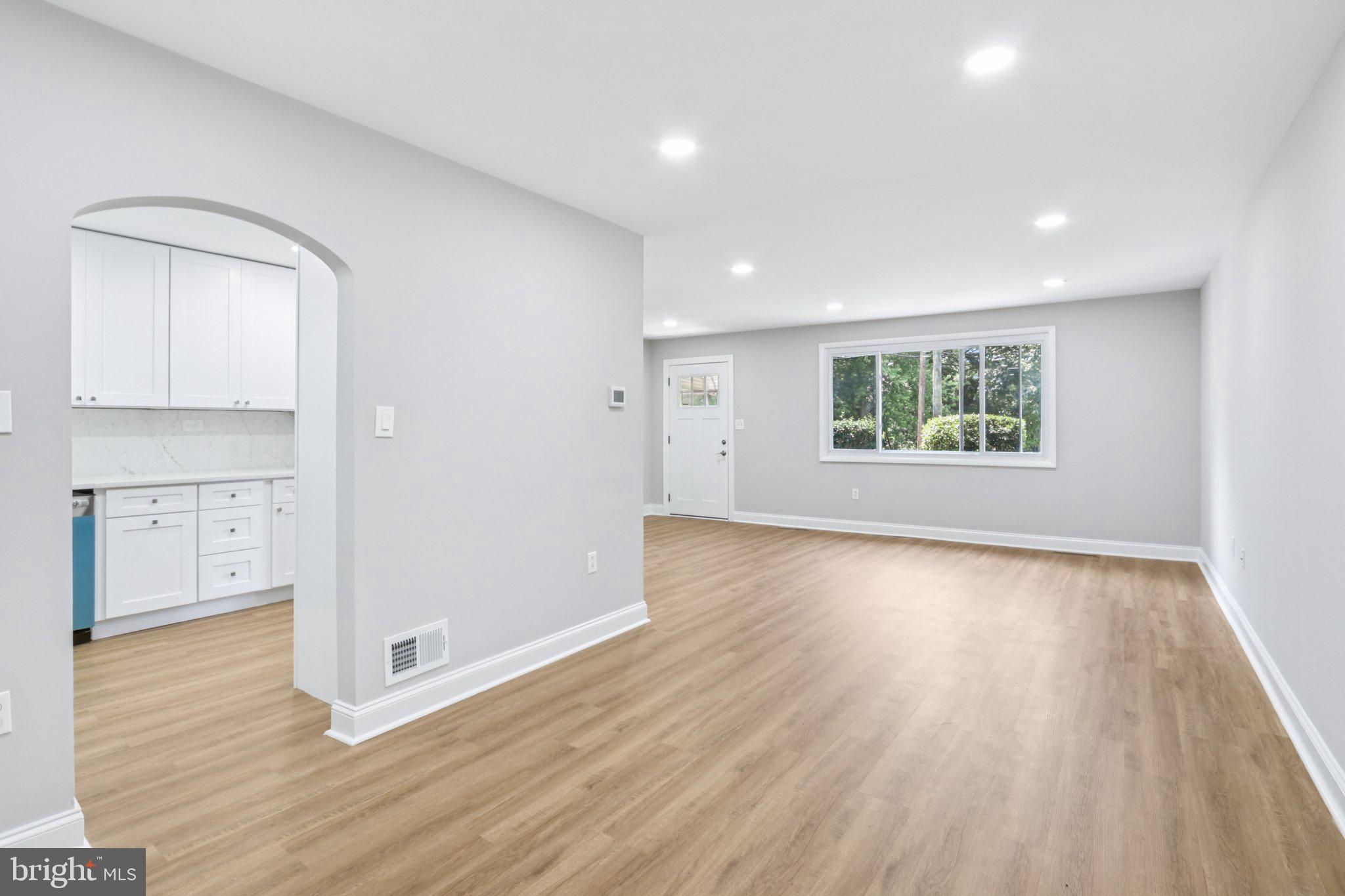 1 Russell Road New Castle, DE 19720 - Photo 9 of 49 an empty room with wooden floor and windows