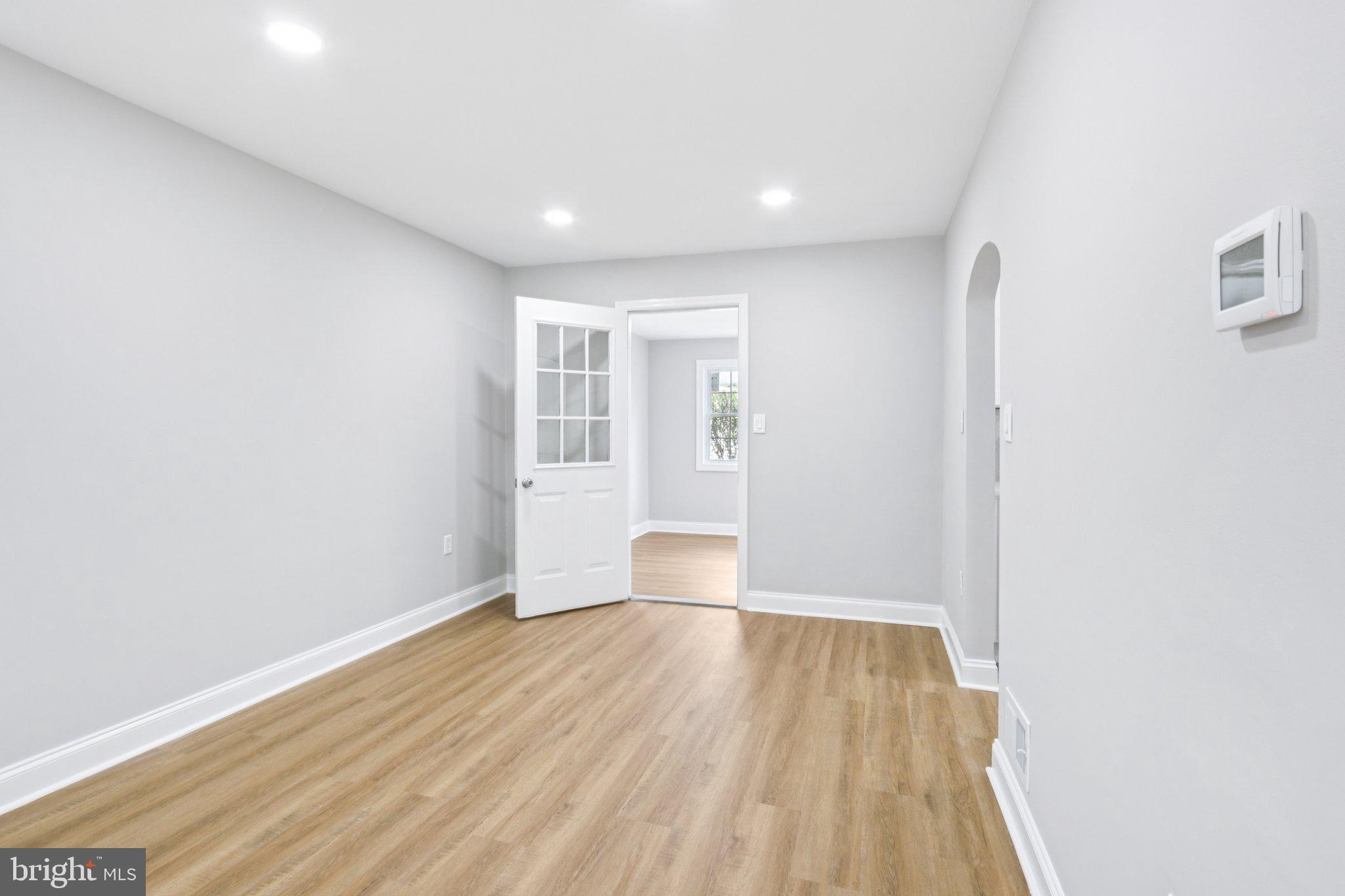 1 Russell Road New Castle, DE 19720 - Photo 10 of 49 an empty room with wooden floor and windows