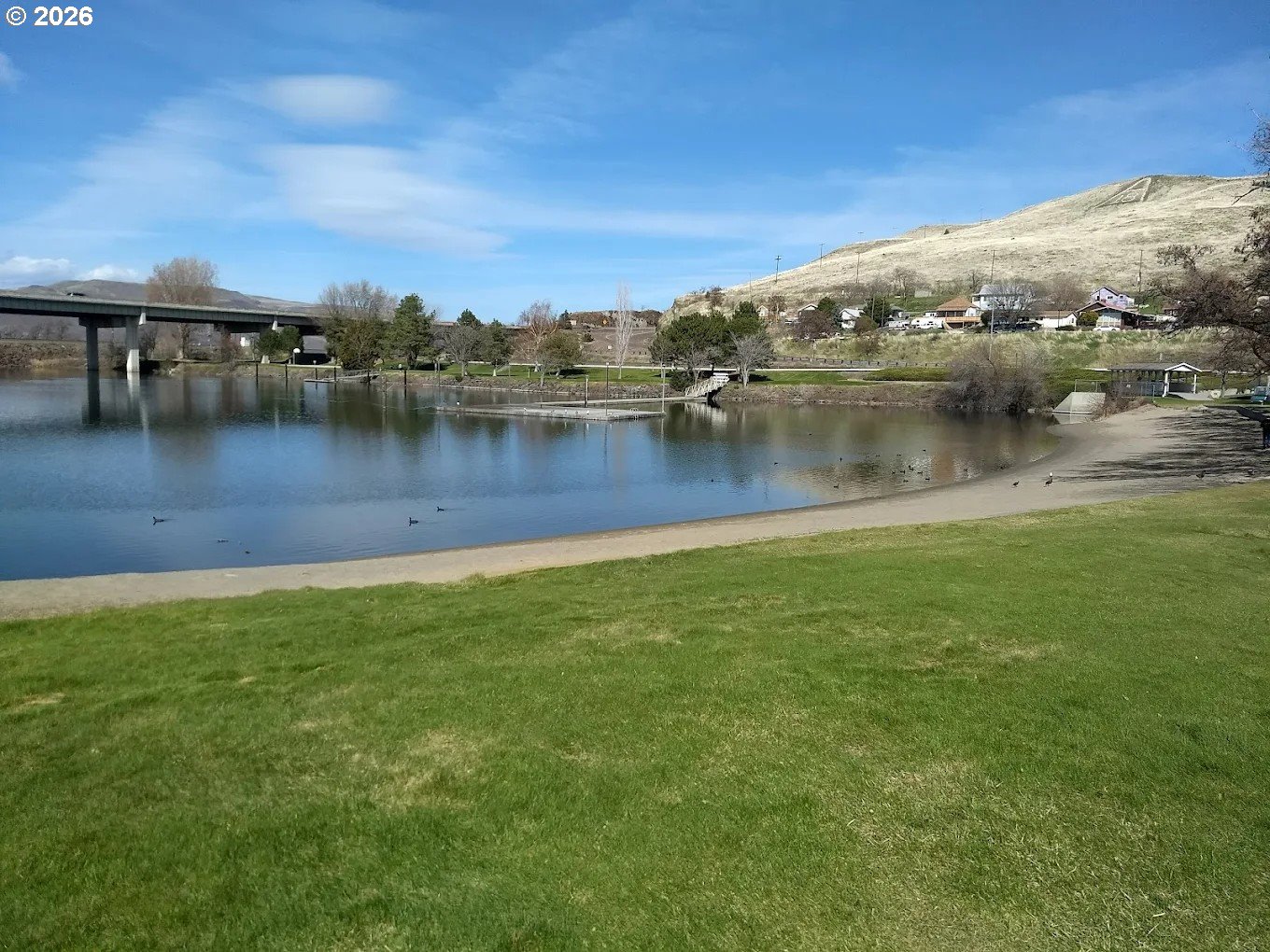 1225 Fairway Loop Arlington, OR 97812 - Photo 13 of 15 a view of a lake with houses in the back