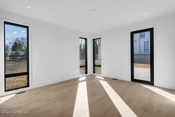 a view of an empty room with glass door