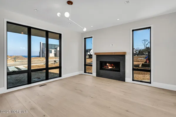 a view of an empty room with a fireplace and a window
