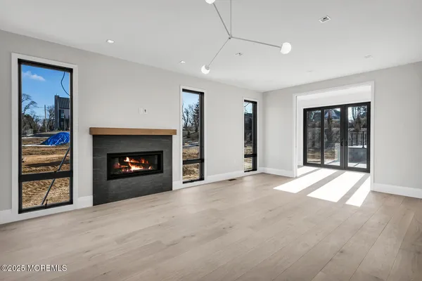 a view of an empty room with a fireplace and a window