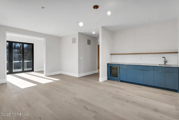 a view of an empty room with a fireplace and a window