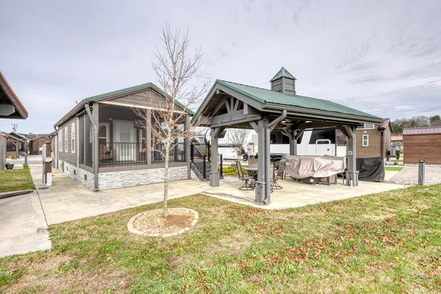 a view of a chairs and table in the patio with a backyard