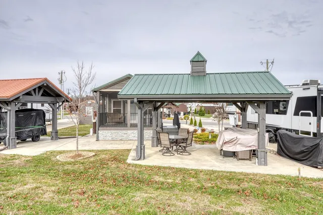 a view of a house with backyard porch and sitting area