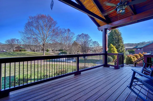 a view of a patio with table and chairs potted plants and palm tree