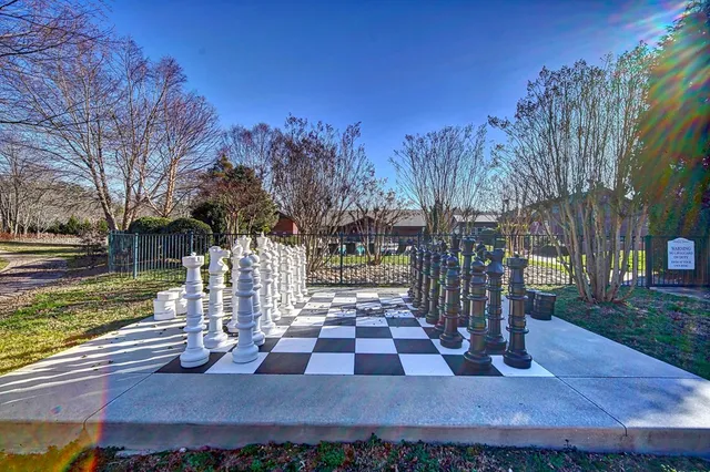 a view of a house with pool fire pit and chairs