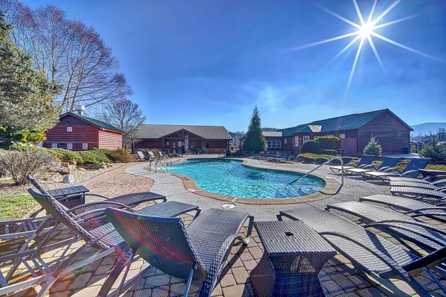 an aerial view of a house with outdoor space pool seating area and fire pit