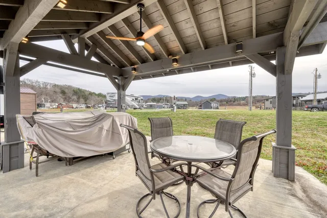 a view of a porch with chairs and backyard