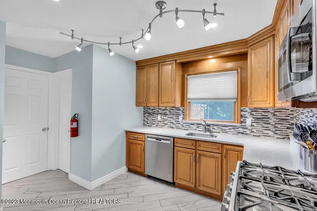 a bathroom with a sink a vanity and a large mirror