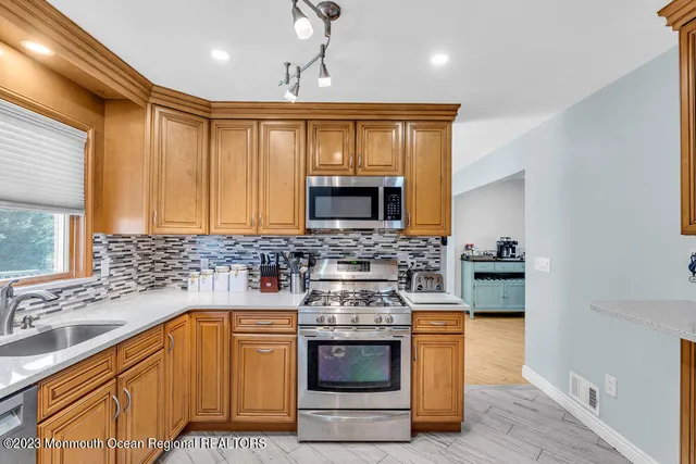a kitchen with stainless steel appliances a stove a sink and a microwave