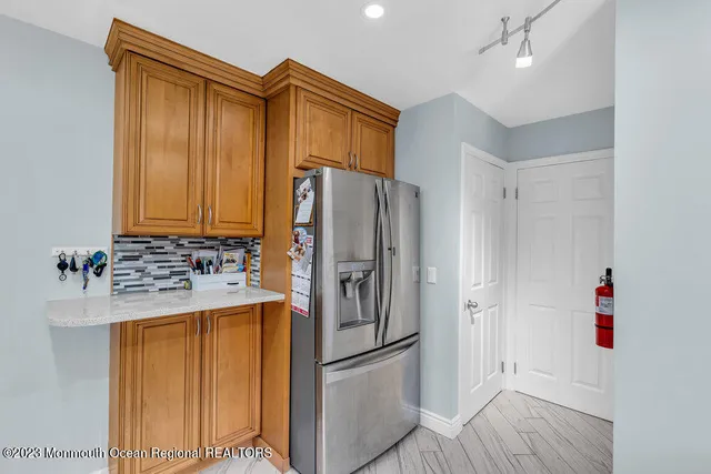 a kitchen with a refrigerator and a sink