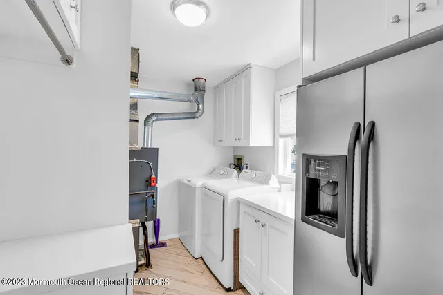 a kitchen with cabinets and a refrigerator
