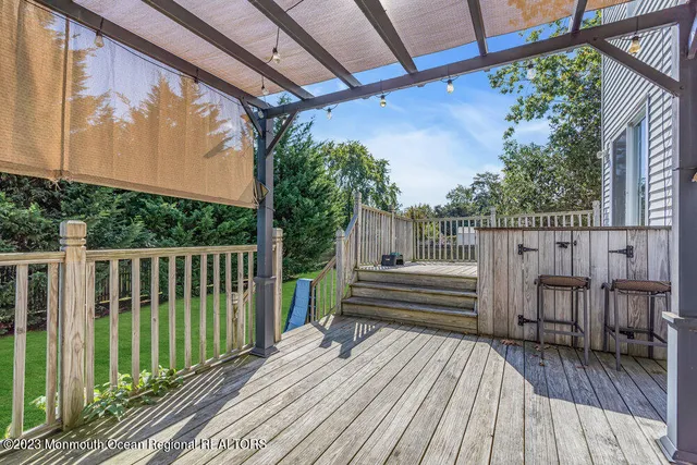 a view of balcony with wooden floor and fence