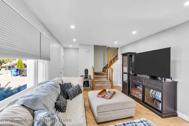 a bedroom with furniture and a flat screen tv