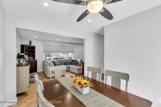a living room with furniture a chandelier and kitchen view