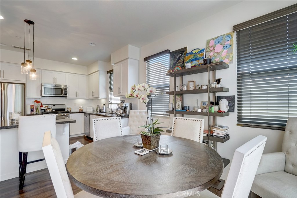 44 Hoya Street Rancho Mission Viejo, CA 92694 - Photo 7 of 32 a dining room with stainless steel appliances kitchen island granite countertop a dining table chairs and a refrigerator