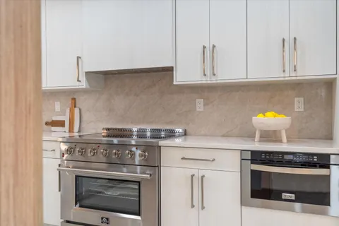 a view of a dining room with furniture a chandelier and window