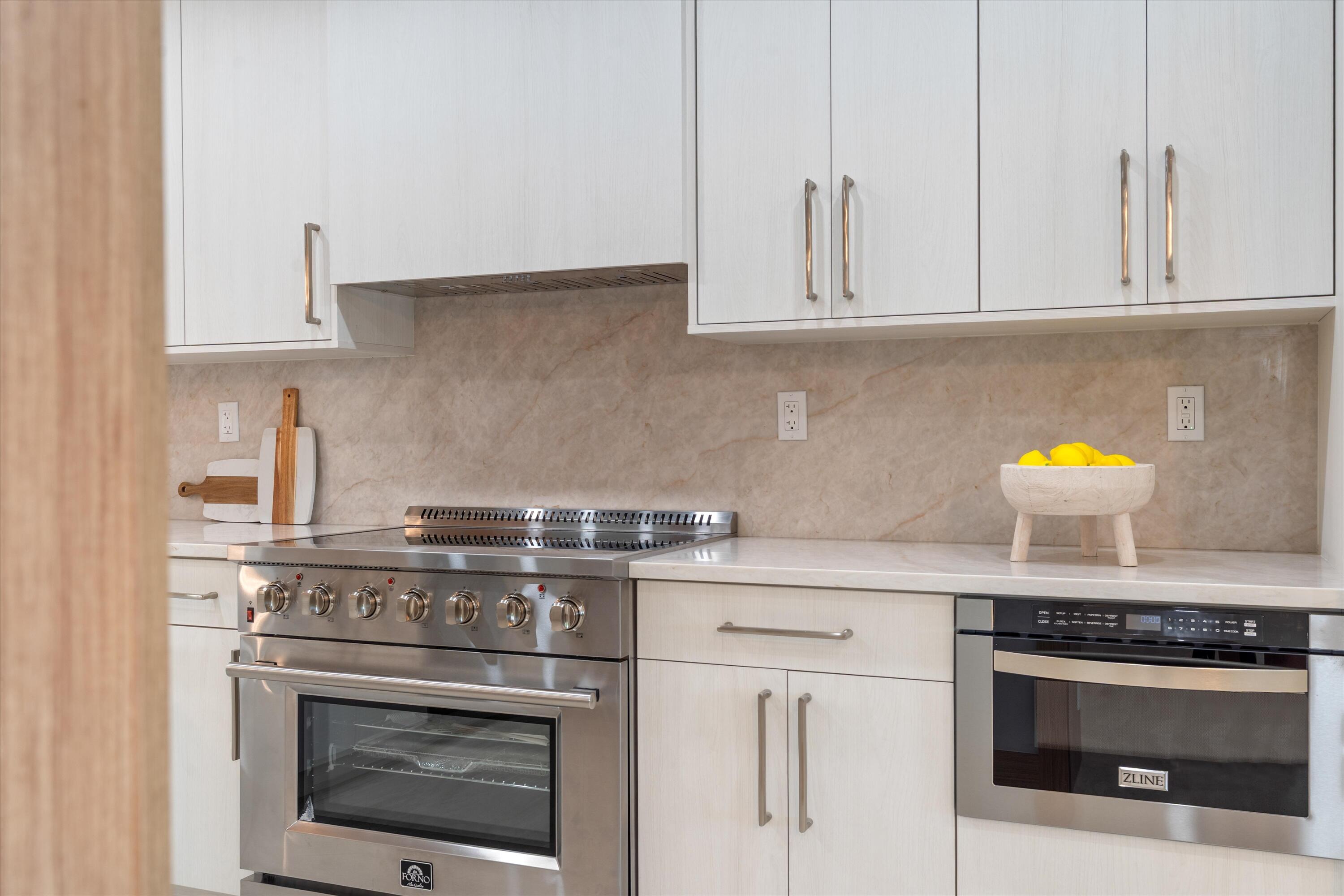 17036 Bay Street Jupiter, FL 33477 - Photo 14 of 69 a stove top oven sitting inside of a kitchen