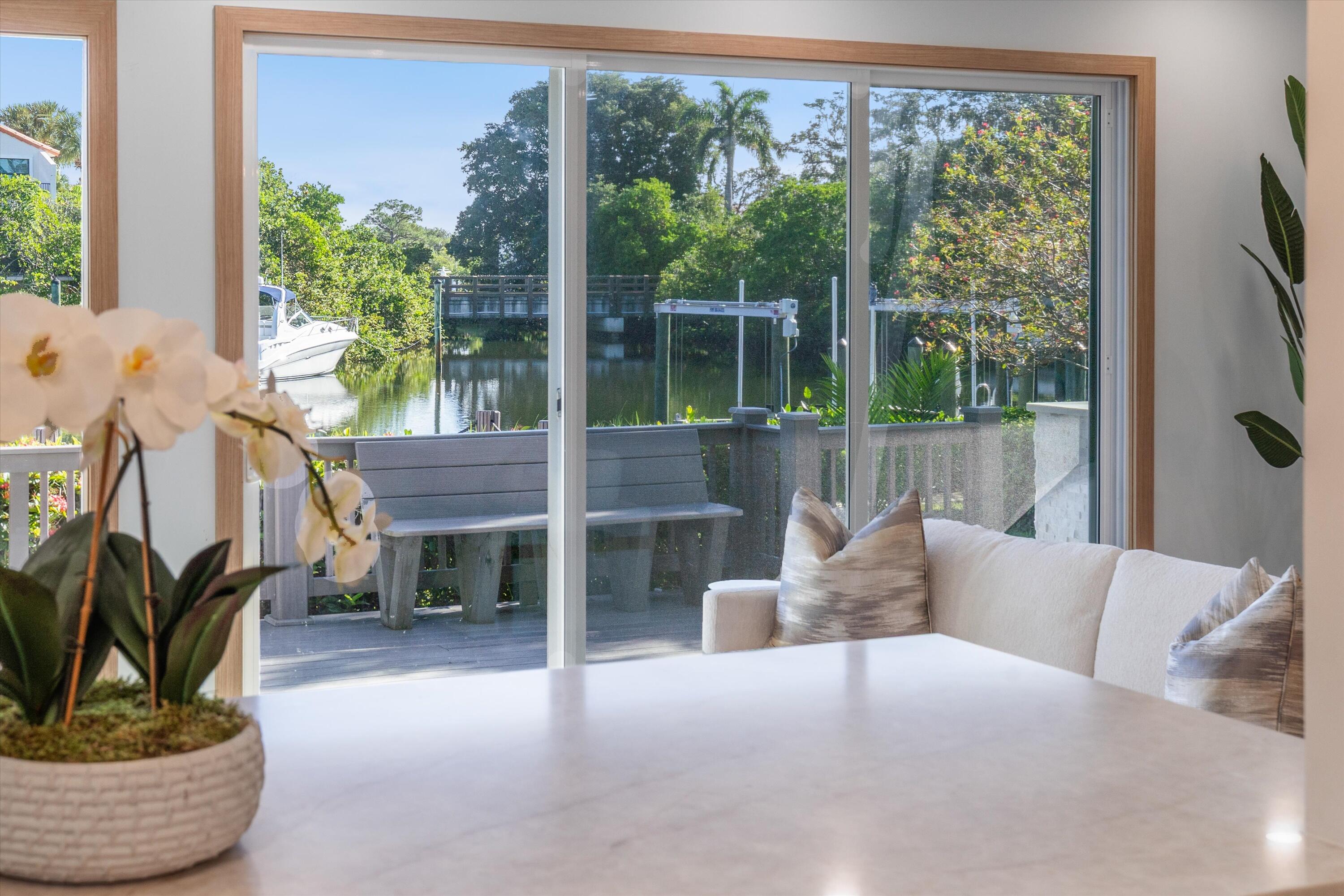 17036 Bay Street Jupiter, FL 33477 - Photo 17 of 69 a living room with furniture and a potted plant