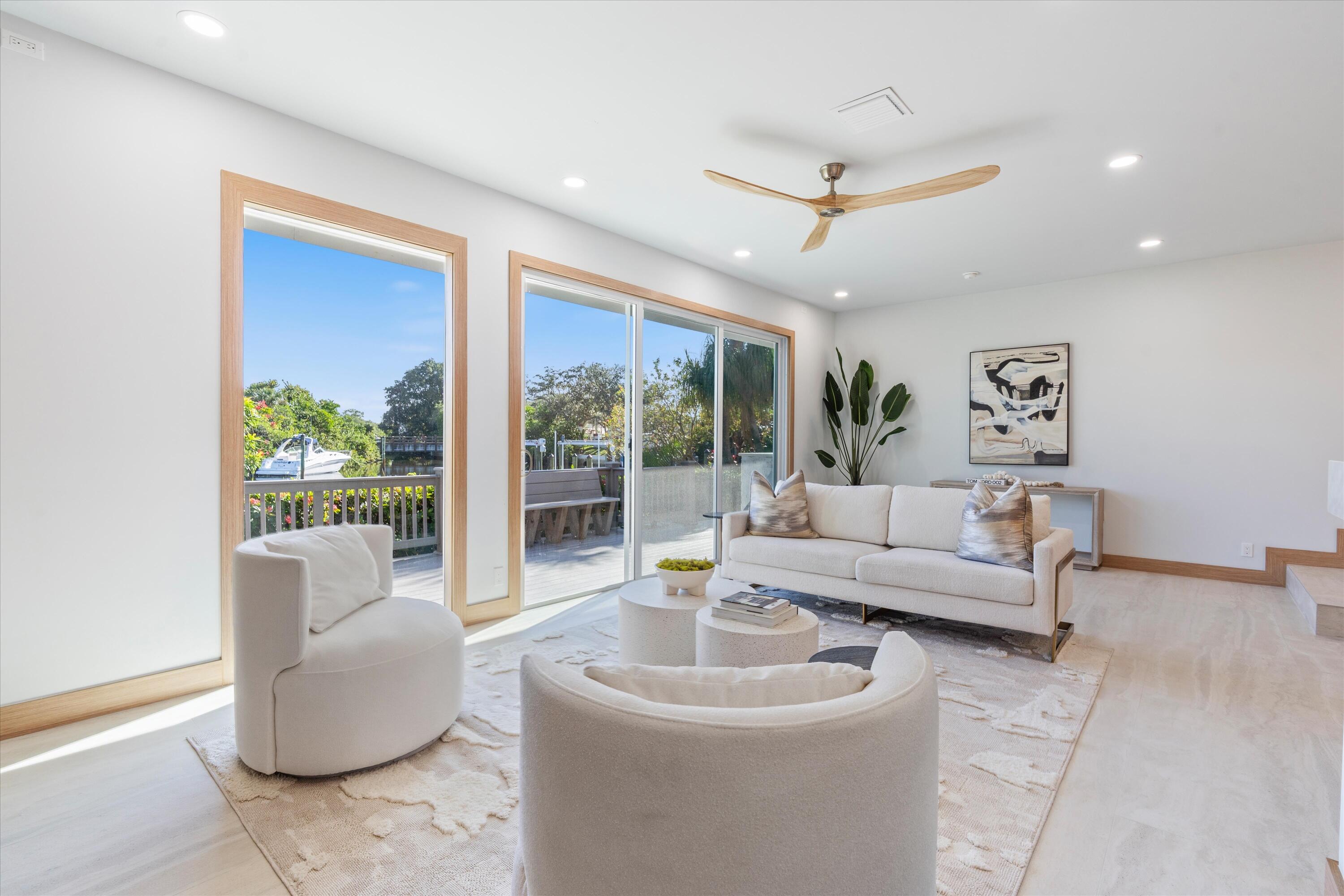 17036 Bay Street Jupiter, FL 33477 - Photo 22 of 69 a living room with furniture and a large window