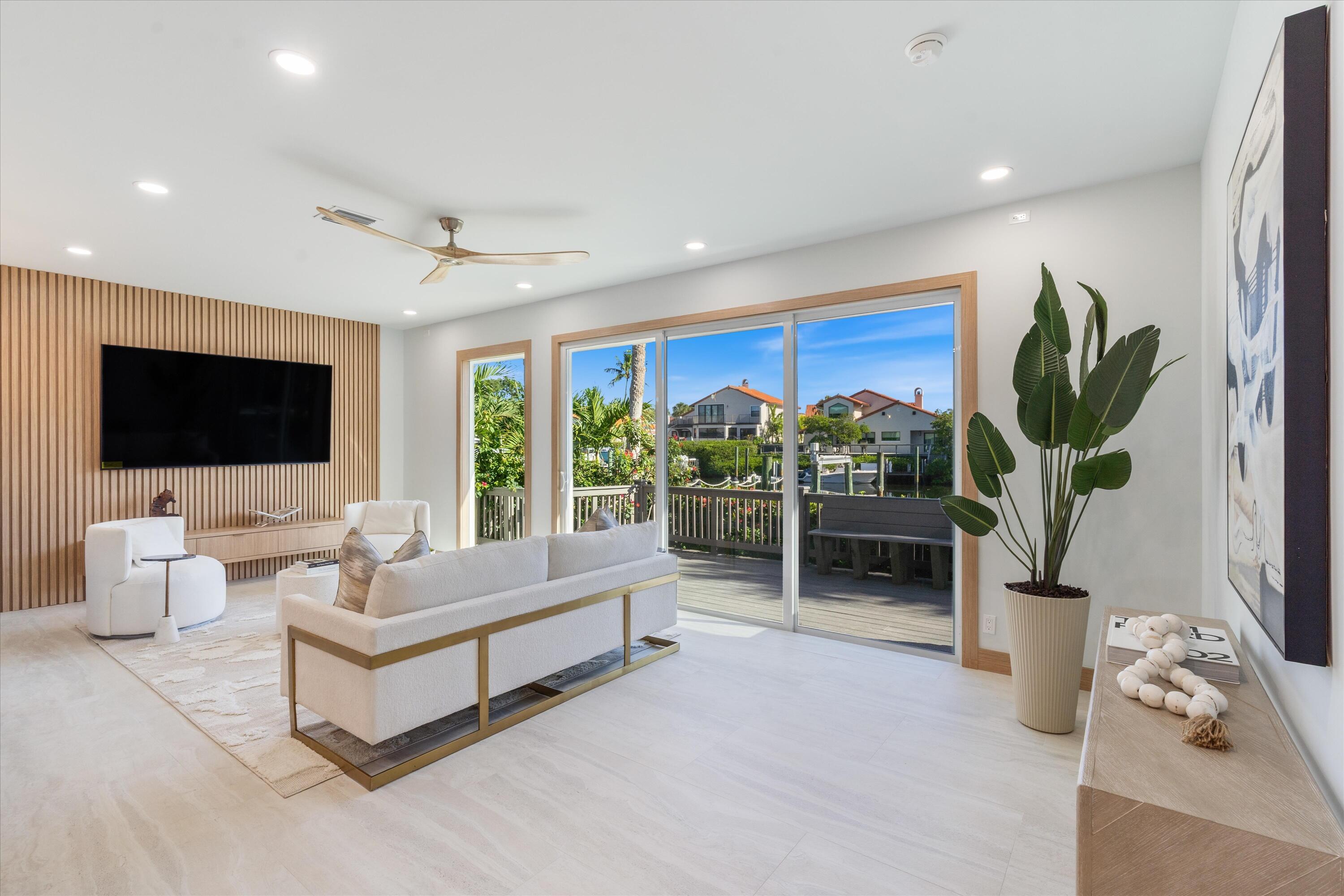 17036 Bay Street Jupiter, FL 33477 - Photo 24 of 69 a living room with furniture fireplace and flat screen tv