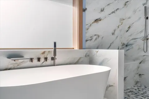 a bathroom with a toilet and a shower