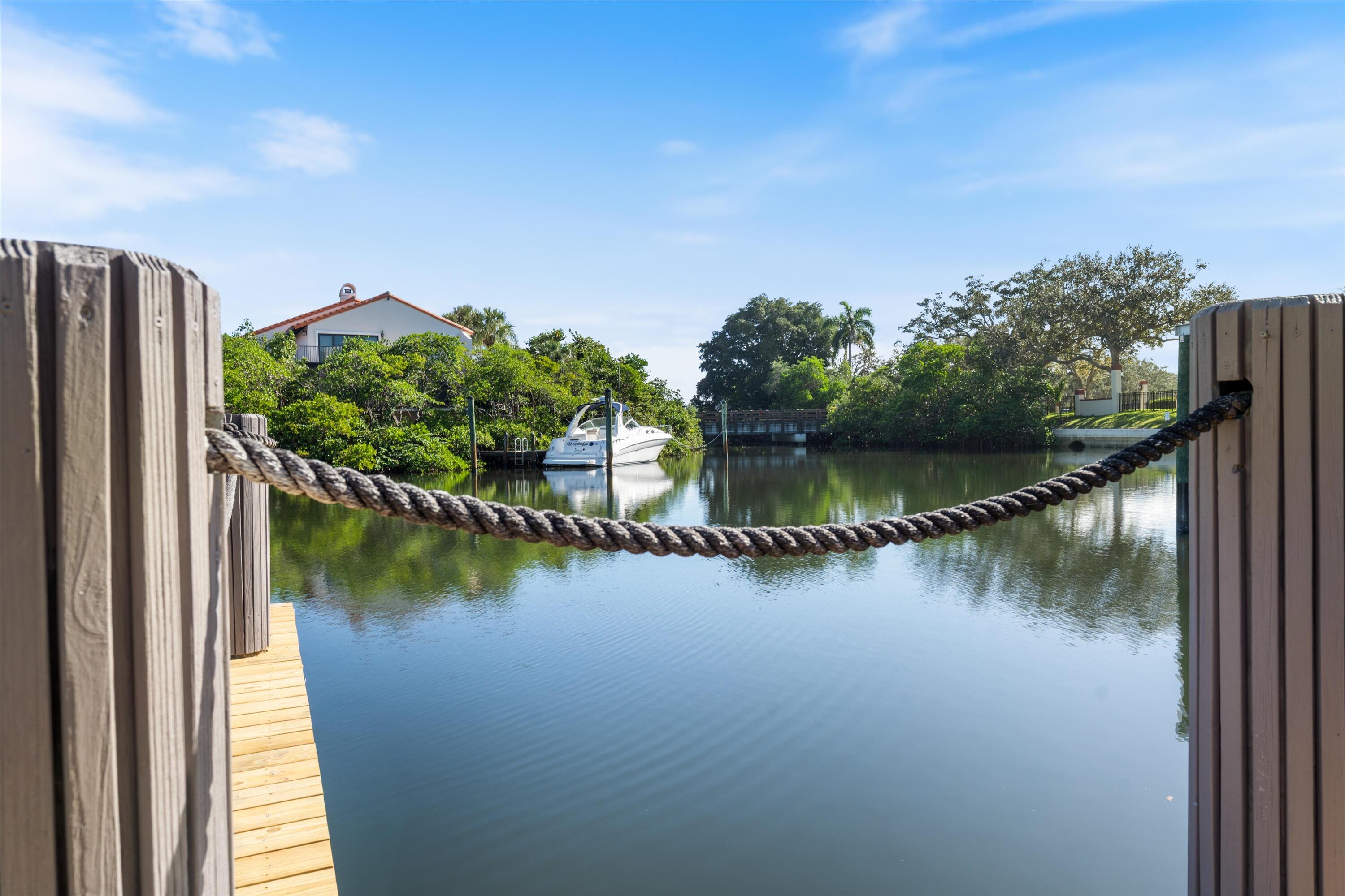 17036 Bay Street Jupiter, FL 33477 - Photo 53 of 69 a view of a lake with a house in the background