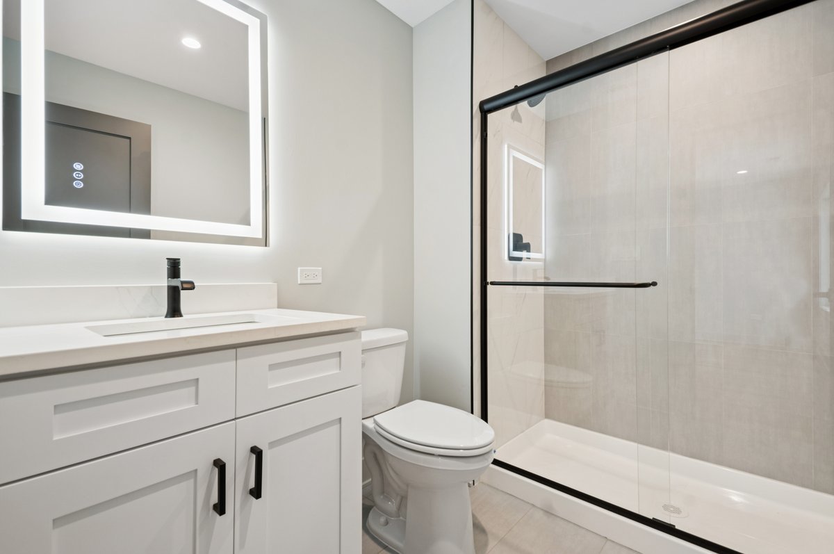 11036 Austin Avenue Chicago Ridge, IL 60415 - Photo 18 of 24 a bathroom with a sink a toilet a shower and a mirror