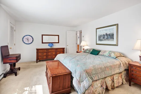 a bedroom with a bed and chair