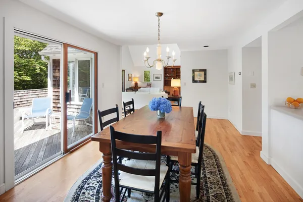 a view of a dining room with furniture large windows and wooden floor